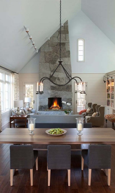 A dining room with a fireplace and a table