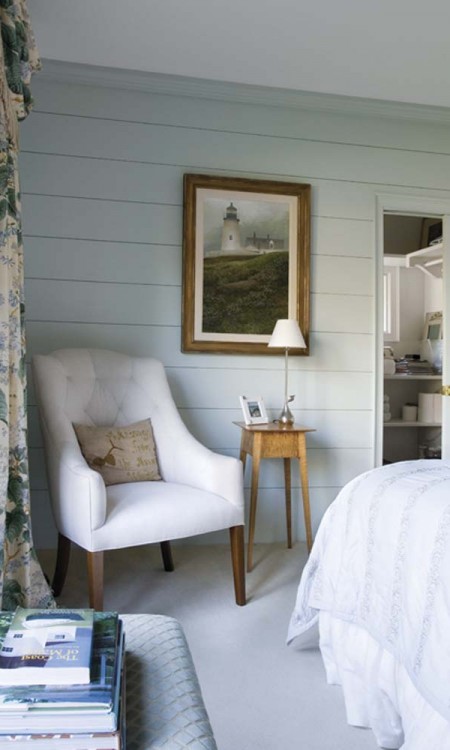 A bedroom with white walls and furniture.