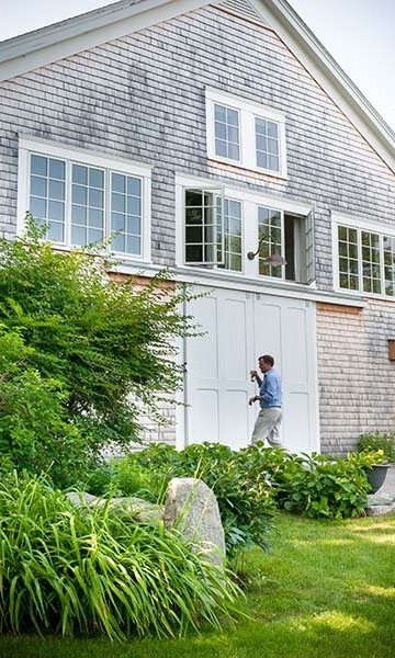 A man standing in front of a white door.