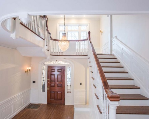 A large foyer with stairs leading to the second floor.