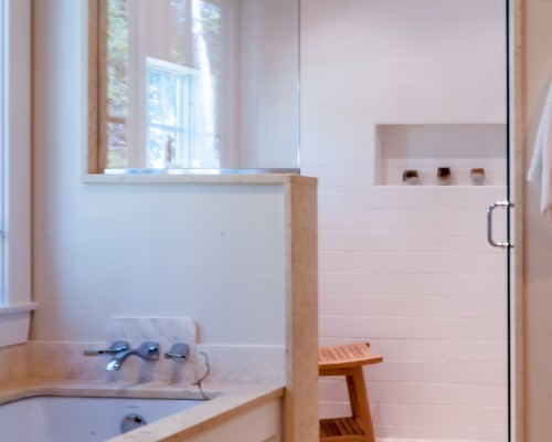 A bathroom with a tub, shower and sink.