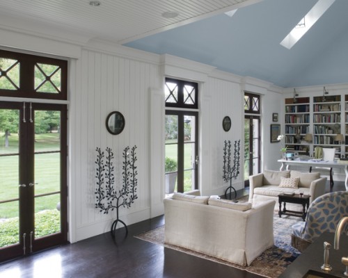 A living room with white furniture and blue walls.