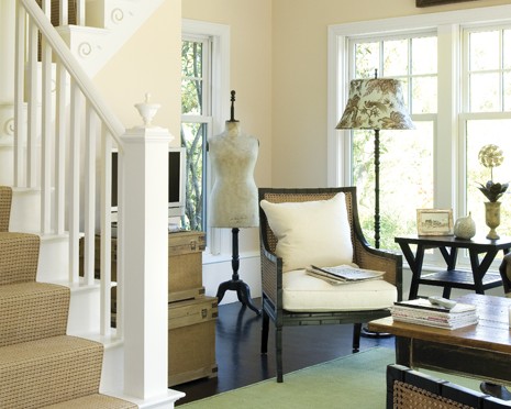 A living room with stairs and furniture in it