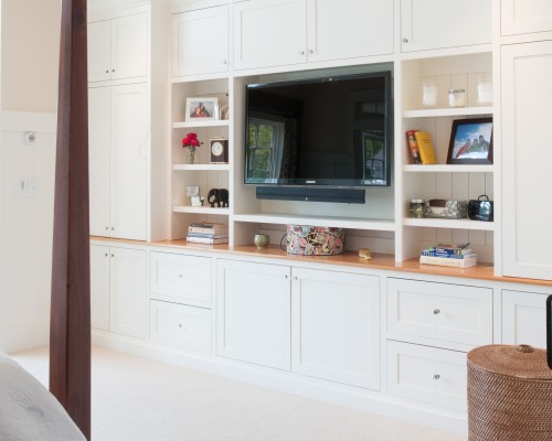 A white entertainment center with a flat screen tv.