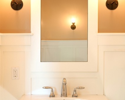 A bathroom with a sink and mirror in it