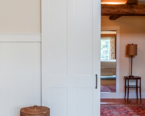 A white door in the middle of a room.